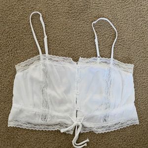 lacy and flowy white crop top with buttons and adjustable straps